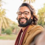 attractive man with glasses and beard taking a sel haweznz